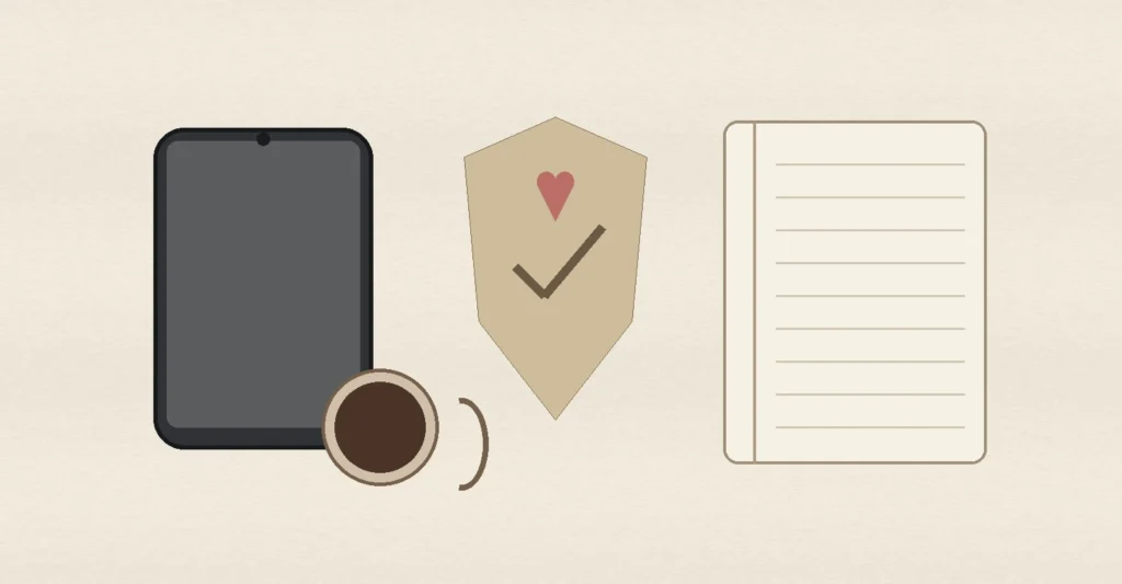 A smartphone, heart shield, coffee mug and blank notebook on a warm table, representing Hinge date safety, boundaries and thoughtful follow-up.